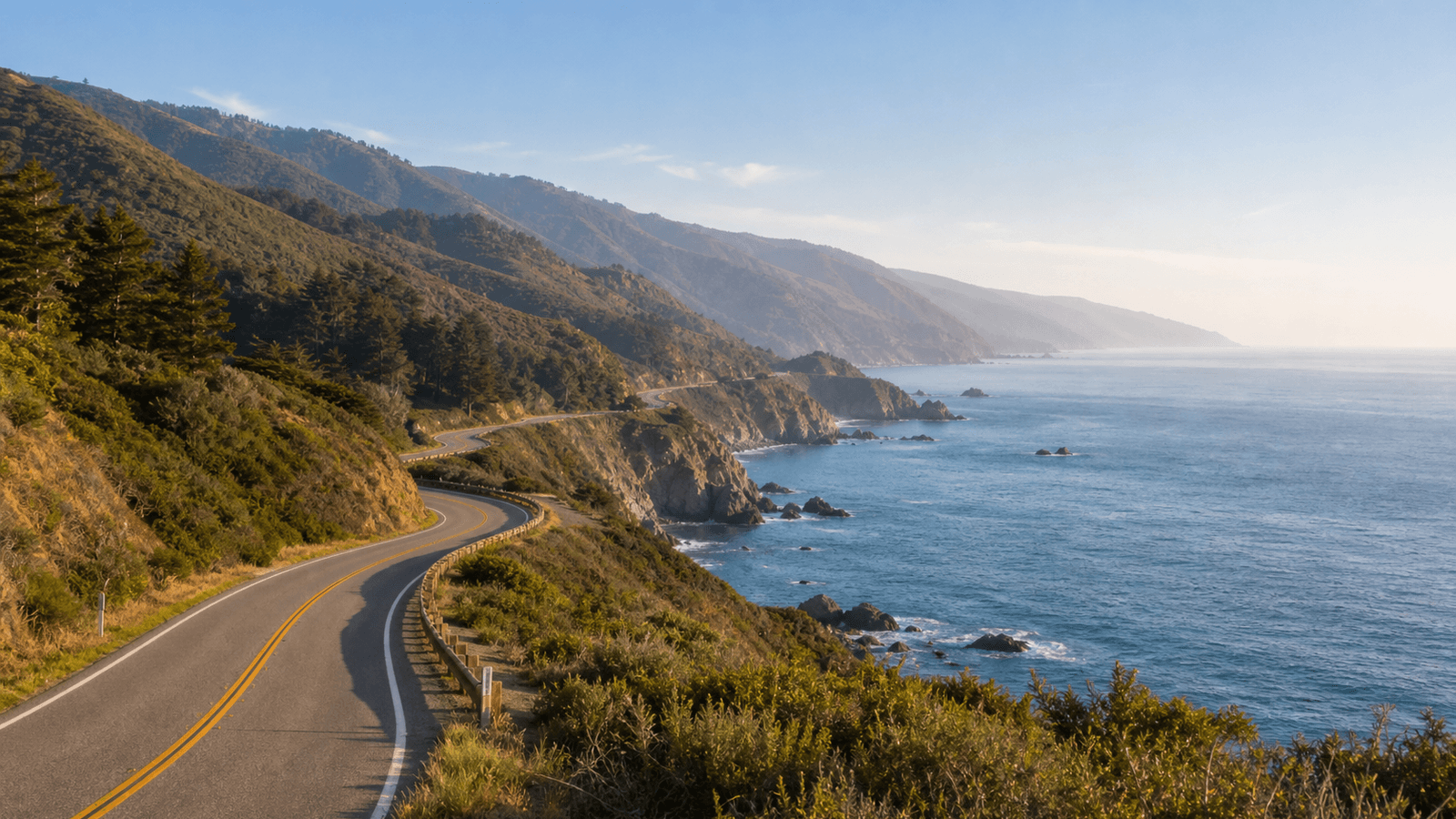 Empty winding road along steep coastal slopes