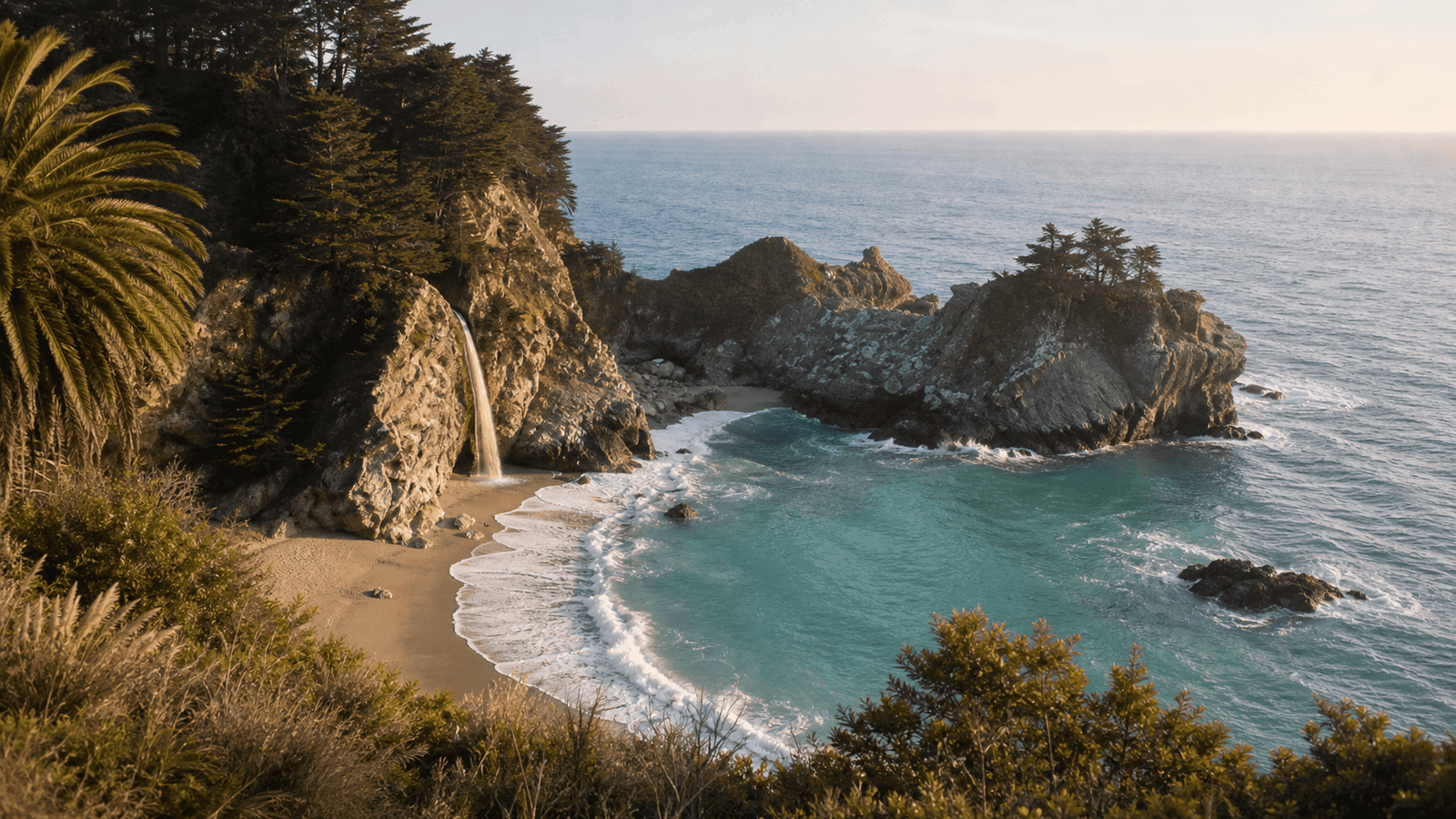 Narrow waterfall dropping from a cliff onto a sandy beach