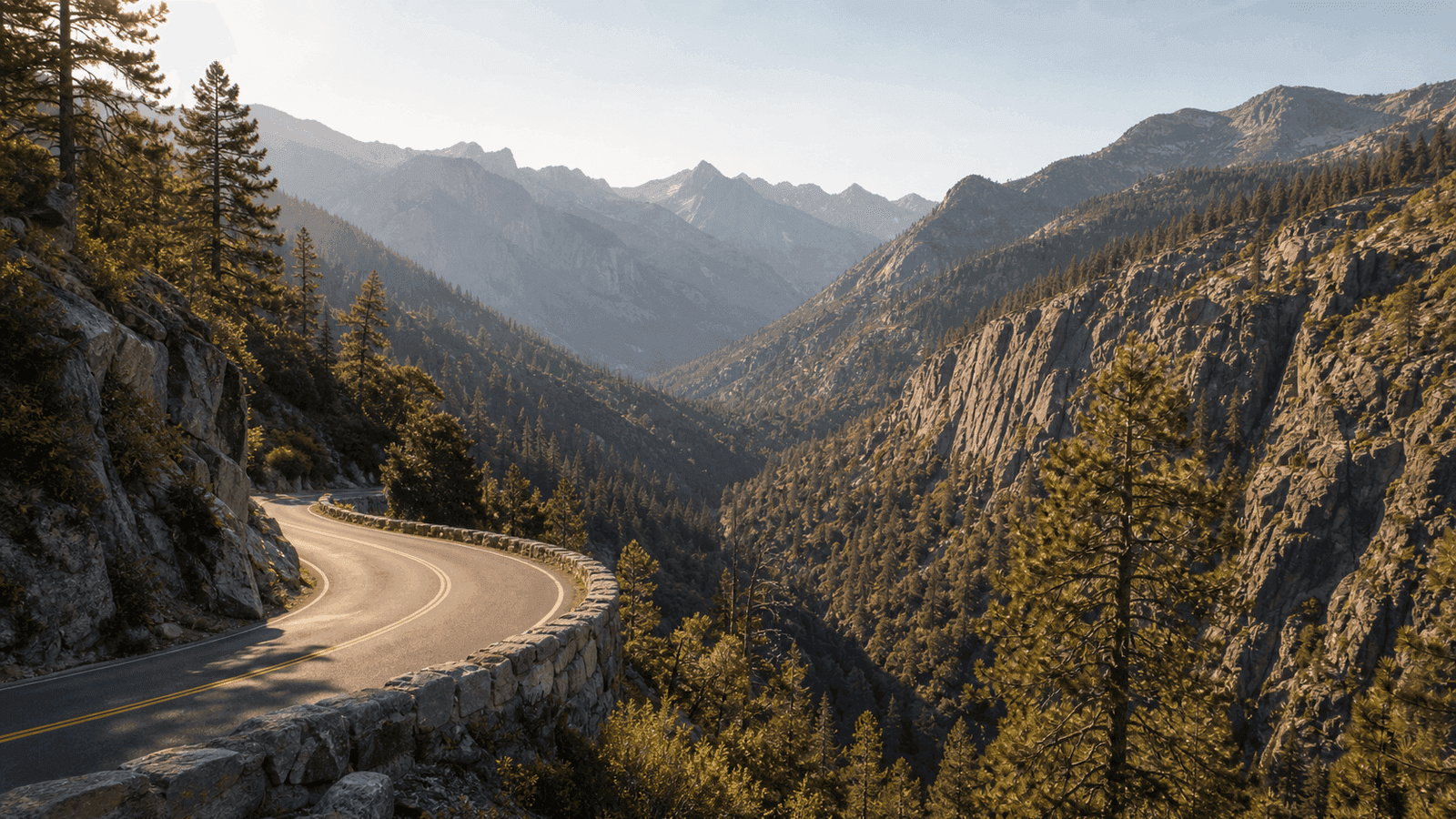Winding mountain road along a wooded valley wall