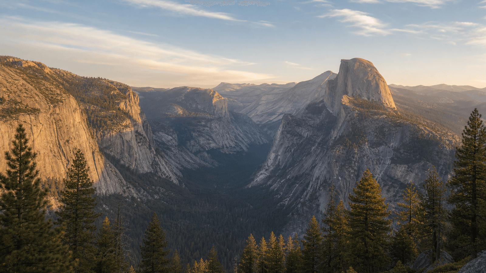 Elevated view over a granite valley with a Half Dome motif