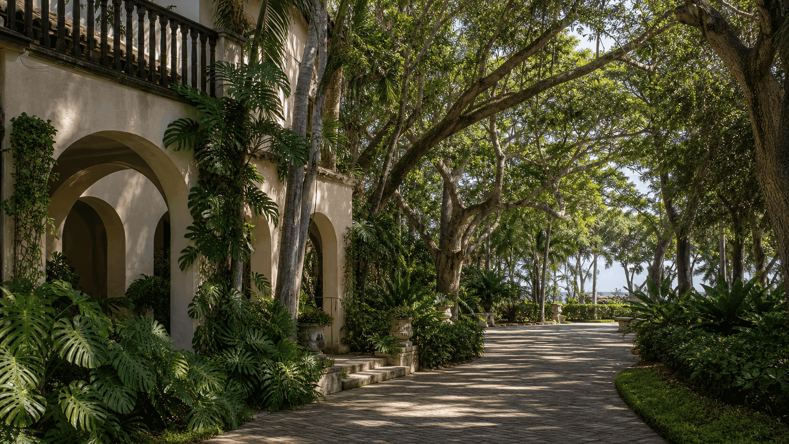 Shaded garden path beside a house with arches