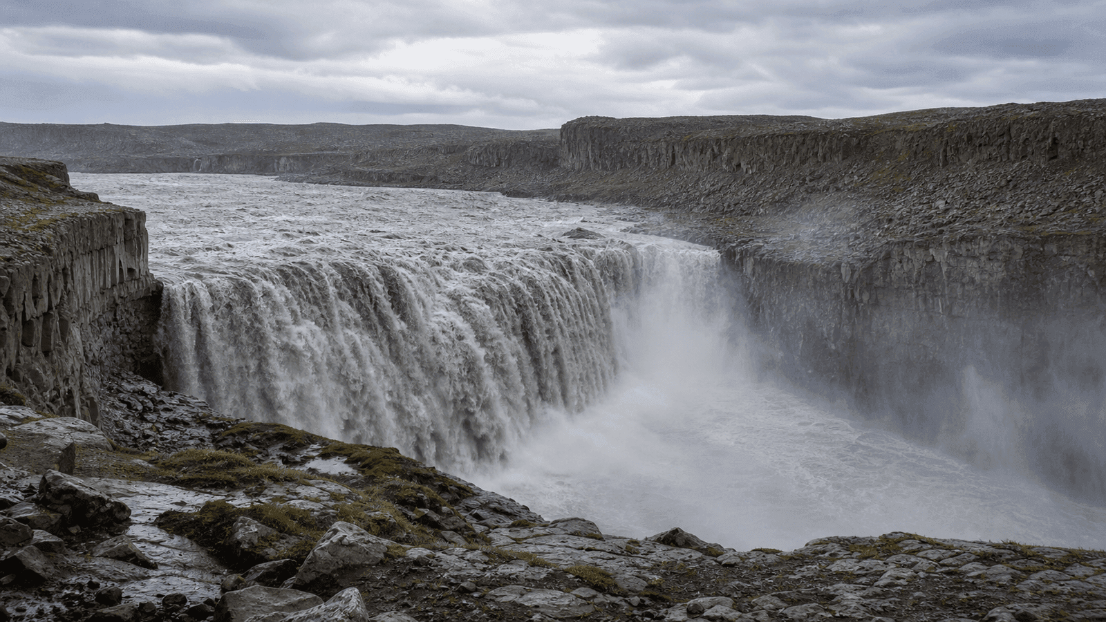 Broad waterfall in a dark gorge