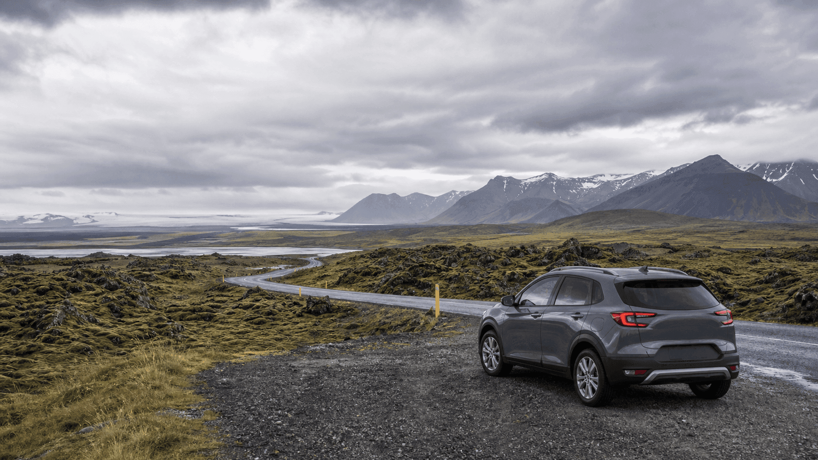 Car in a lava and mountain landscape