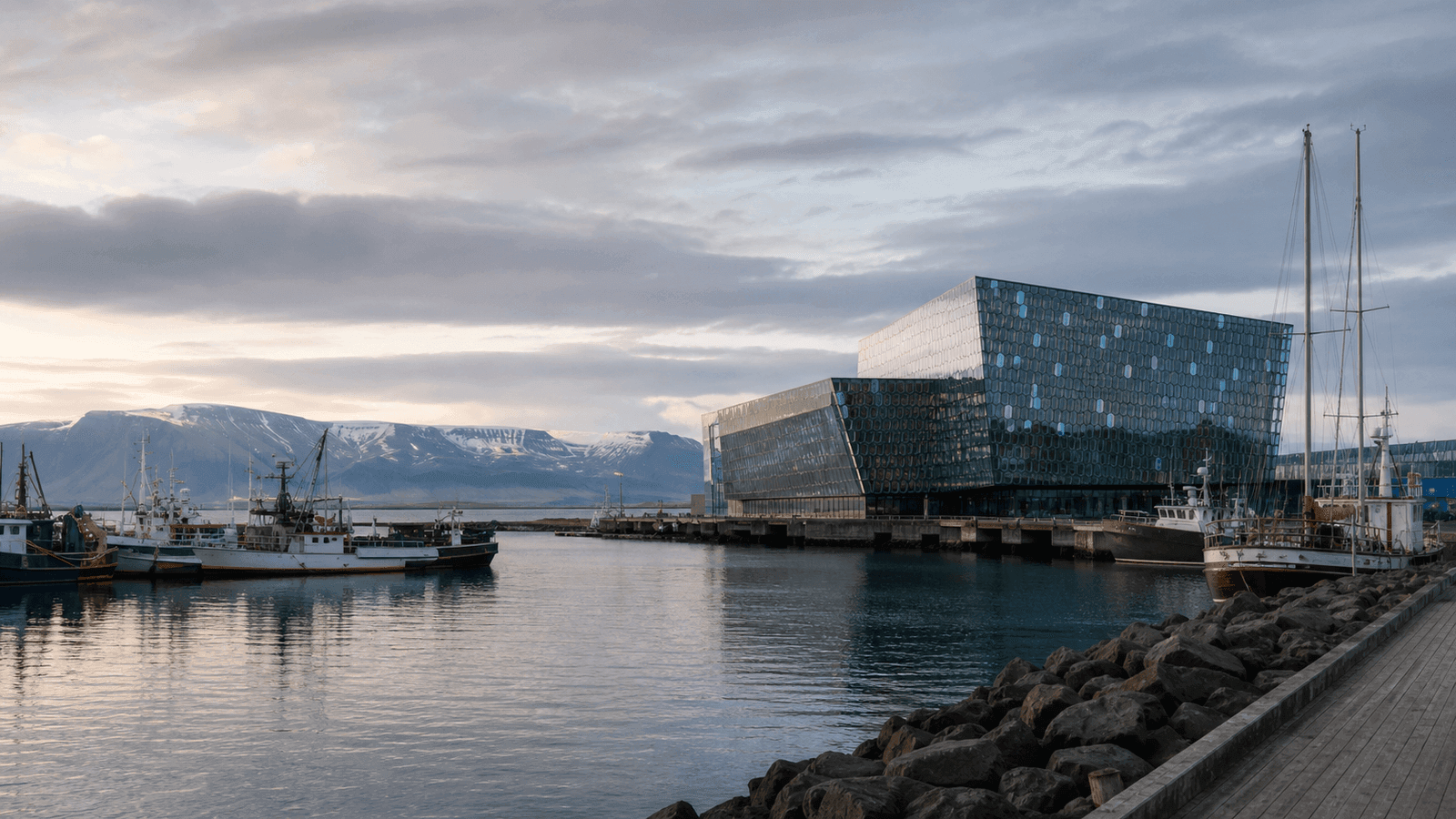 Glass building and boats at a harbour