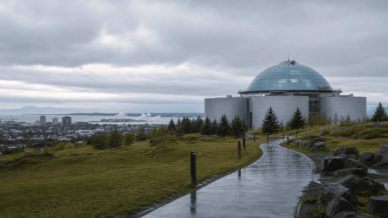 Glass-domed museum on a green hill