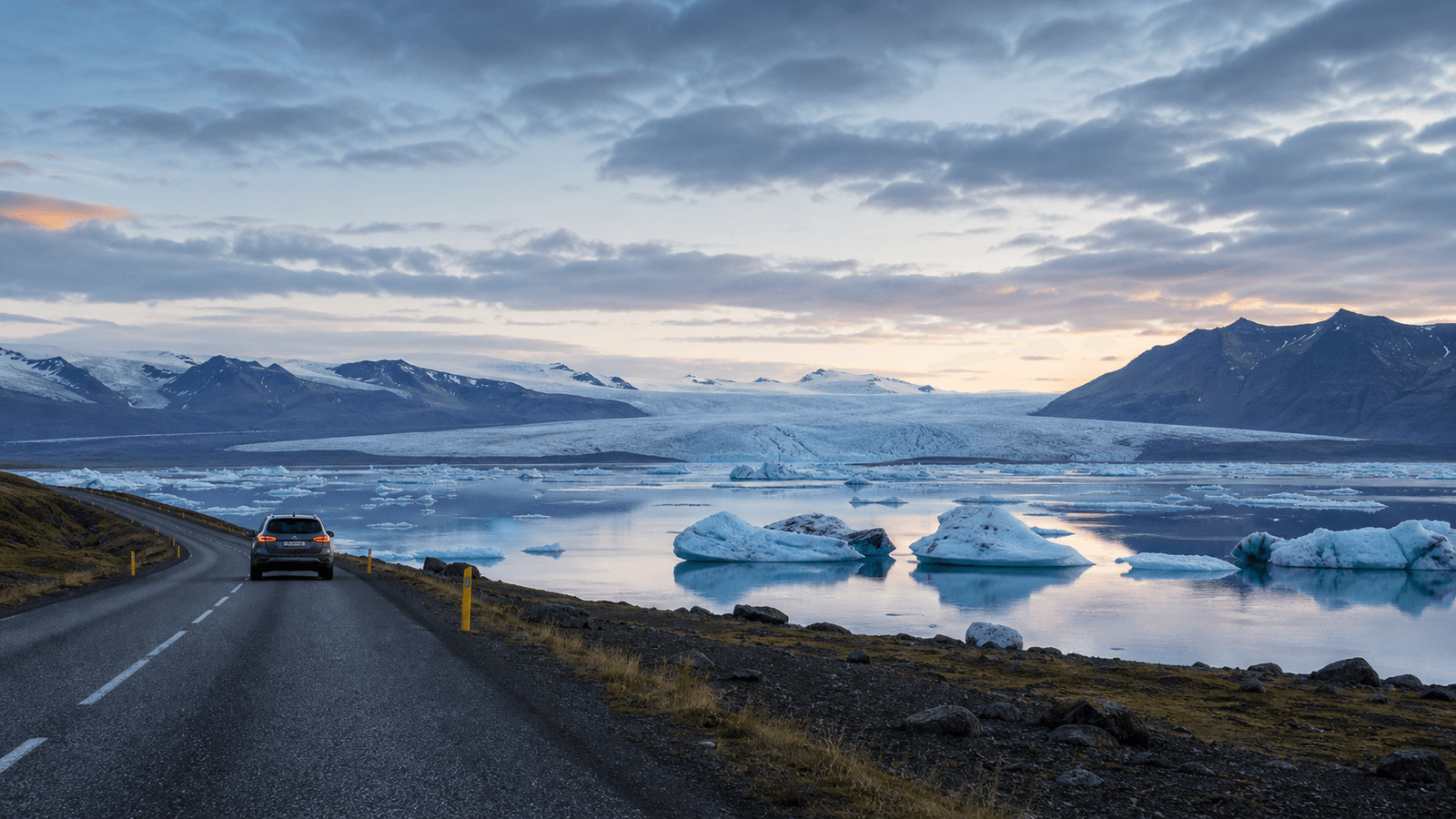 Car and road beside a glacier lagoon in an illustrative scene