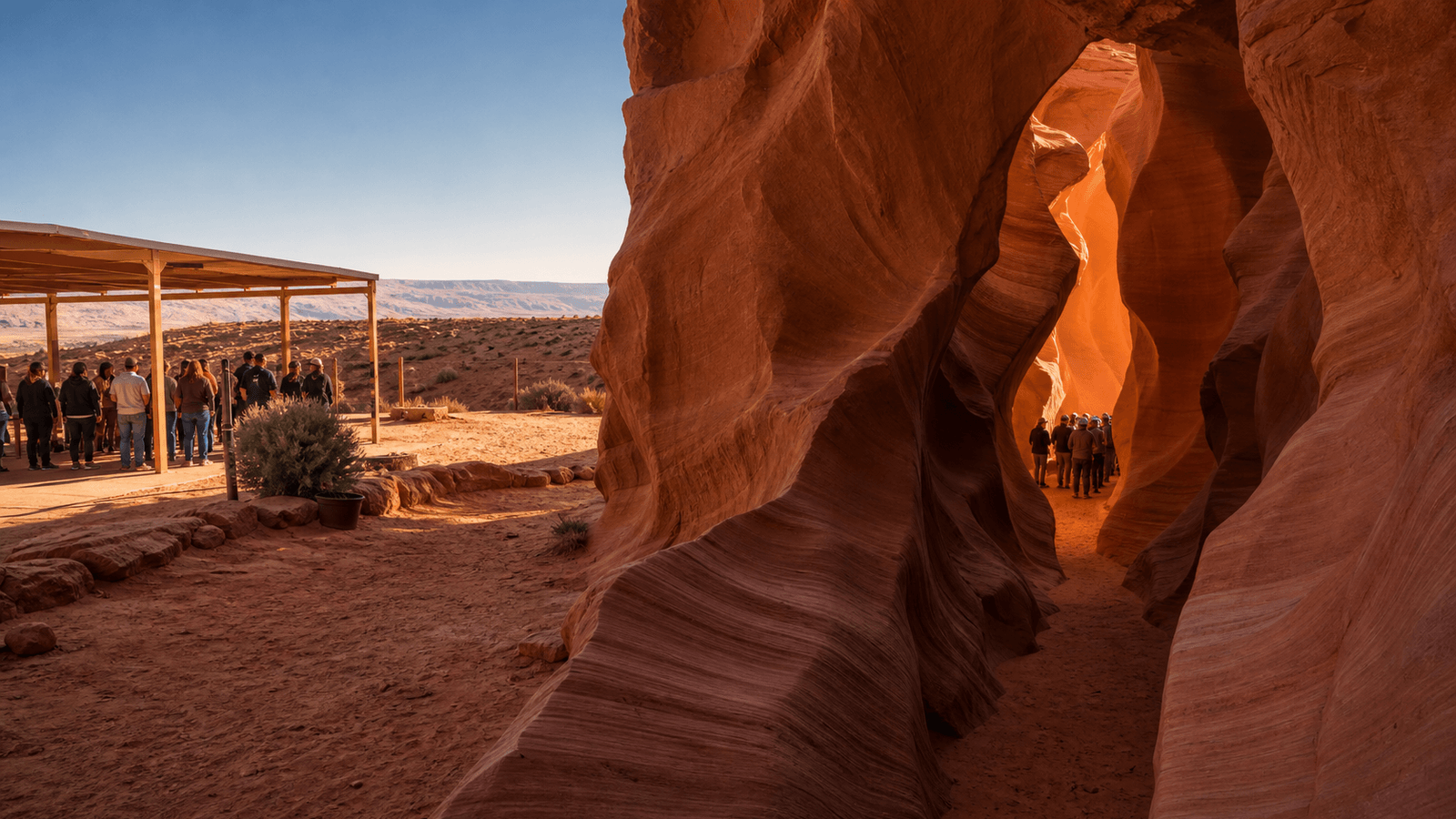 Visitor group at the entrance to a red sandstone canyon