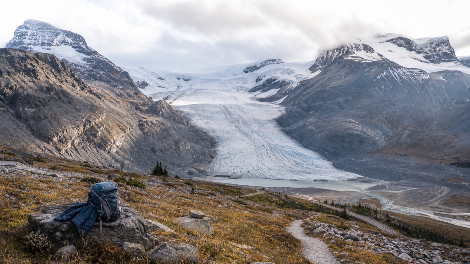 Glacier and rocky moraines beneath high mountains