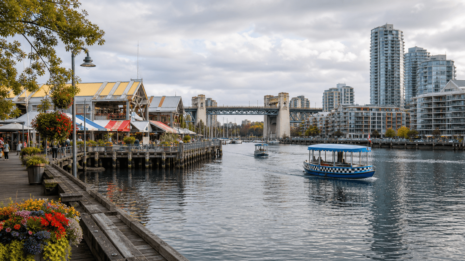 Small ferry on False Creek between market buildings and a bridge